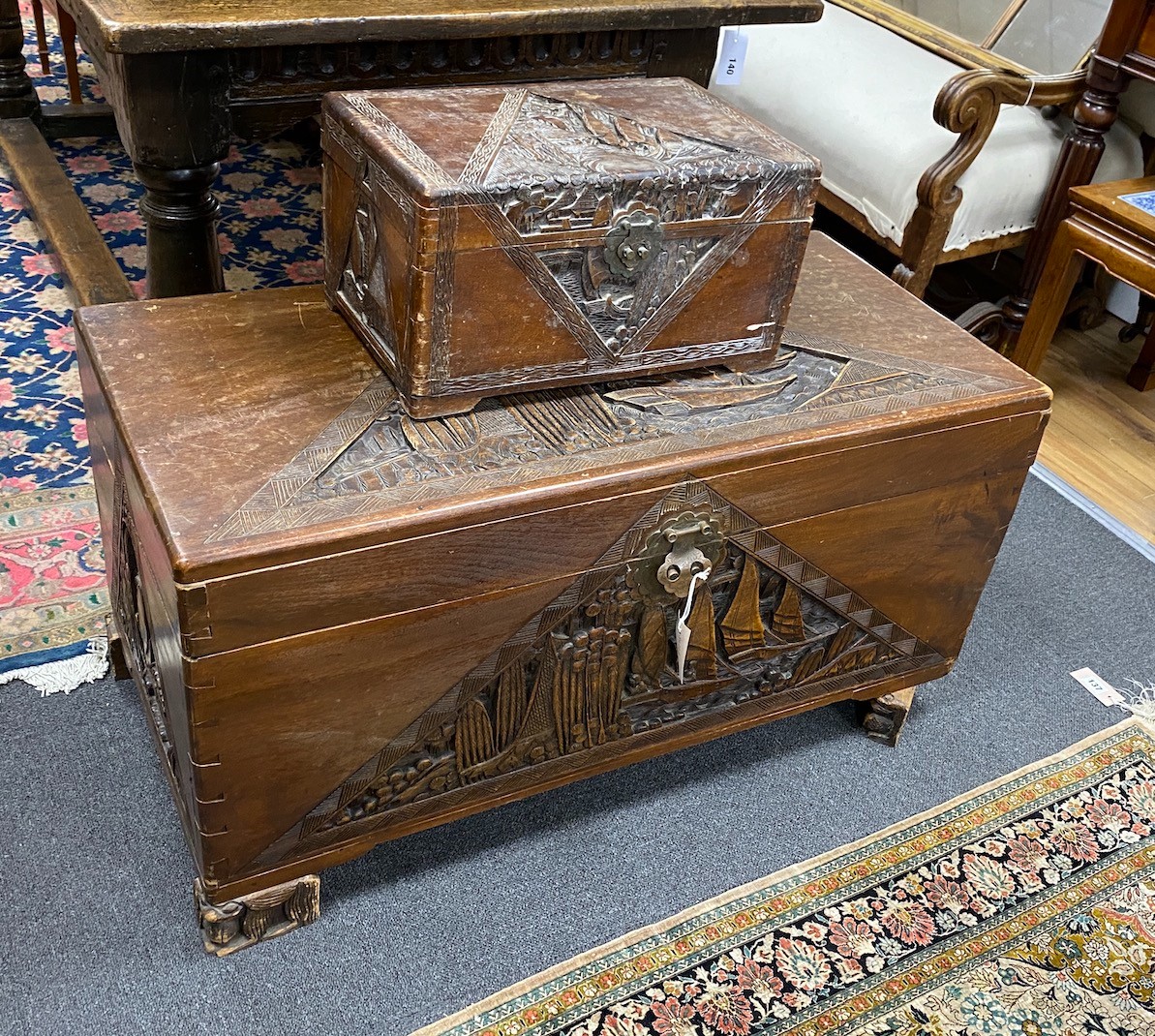 A Chinese carved camphorwood coffer and similar smaller box, larger length 93cm, depth 44cm, height 49cm